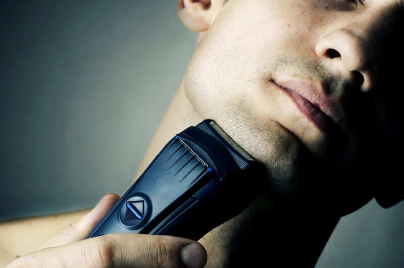 using an electric razor to cut hair